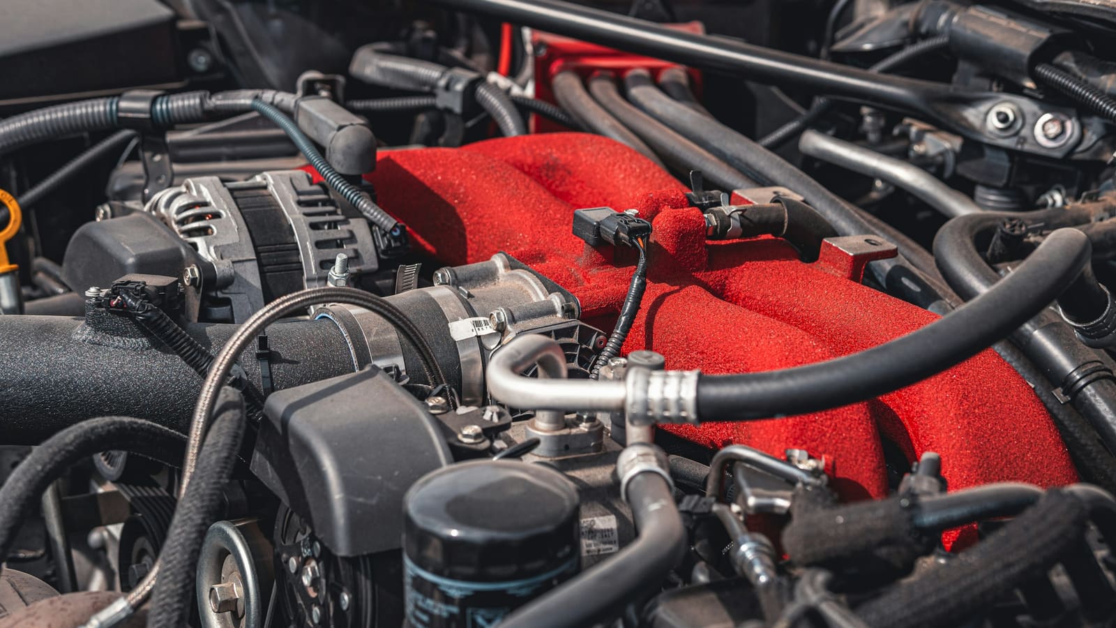Wiring harness routed across an engine bay, close-up of connectors and routed cable runs.